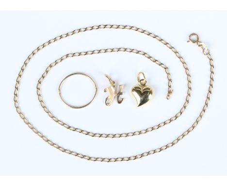A 9ct gold faceted curblink neckchain, weight 2.5g, length 45.5cm, a gold heart shaped pendant, detailed '585', weight 0.8g, 