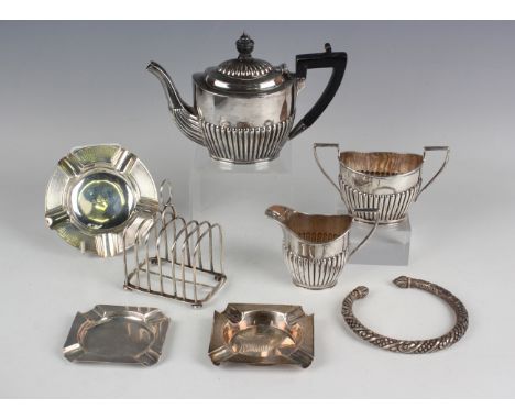 A Victorian silver half-reeded oval bachelor's three-piece tea set, London 1891 and 1892 by Charles Boyton, height of teapot 