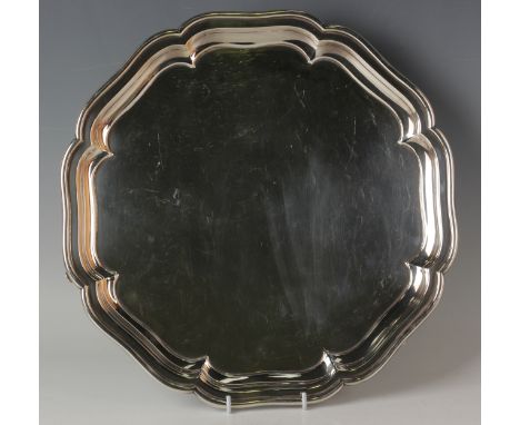 A George V silver salver with piecrust rim, on volute scroll feet, Chester 1932 by S. Blanckensee &amp; Son Ltd, weight 1088.
