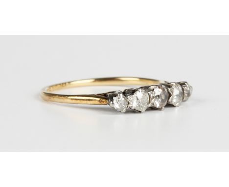 A gold, platinum and diamond five stone ring, mounted with a row of cushion cut diamonds graduating in size to the centre sto