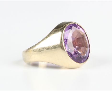 A 9ct gold ring, collet set with an oval cut amethyst, Sheffield 1998, weight 8.7g, ring size approx M.Buyer’s Premium 29.4% 