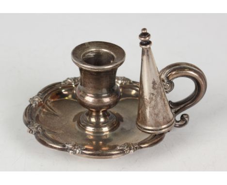 An early Victorian silver chamberstick with urn shaped sconce, the stand with foliate decorated lobed and reeded rim, flanked