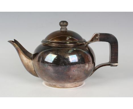 A Dutch Art Deco silver teapot of squat globular form with domed cover, fitted with hardwood handle and finial, Voorschoten 1
