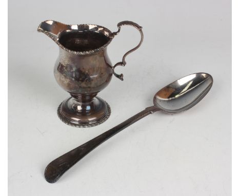 A George III silver cream jug with gadrooned rims, London 1772, no maker's mark, height 10cm, and a George III silver feather