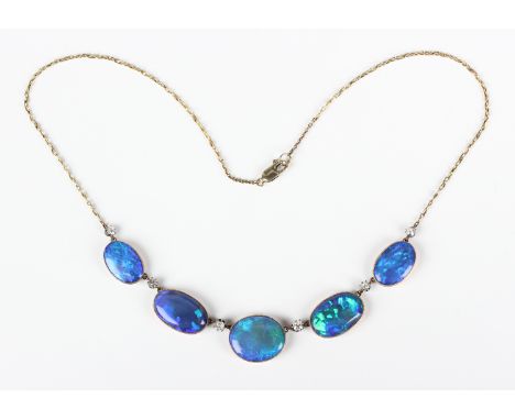 An Edwardian gold, black opal and diamond necklace, the front collet set with a row of five graduated oval black opals altern