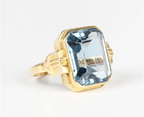 A gold ring, claw set with a cut cornered rectangular step cut synthetic blue spinel, detailed '750', weight 7.2g, ring size 