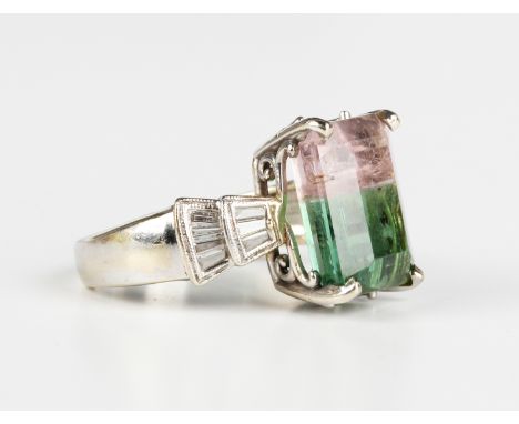 A white gold ring, claw set with a cut cornered rectangular step cut watermelon tourmaline between diamond set shoulders, det