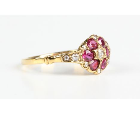 A gold, ruby and diamond ring in a 19th century inspired design, mounted with the principal rose cut diamond within a surroun