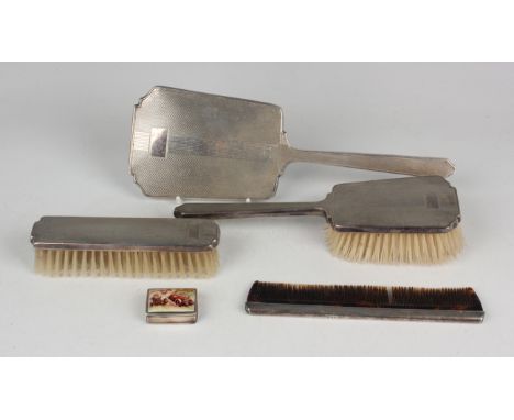 An Elizabeth II silver engine turned four-piece dressing table set, comprising hand mirror, hairbrush, clothes brush and comb