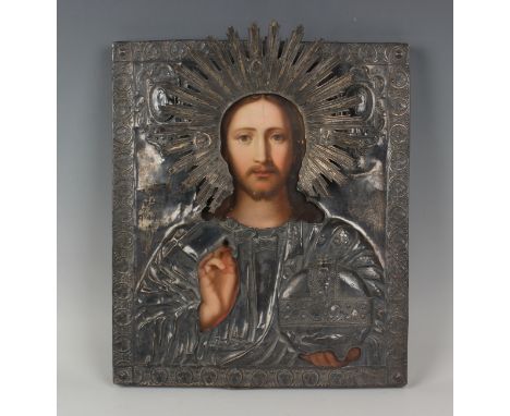 An early 19th century Russian silver mounted icon, 84 zolotnik, depicting Christ Pantocrator, finely painted on wood panel wi