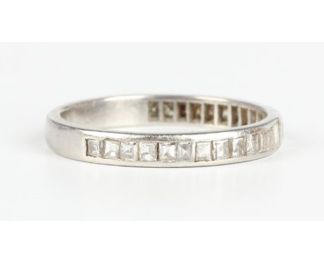 A diamond half-eternity ring, channel set with baguette cut diamonds, unmarked, ring size approx P.Buyer’s Premium 29.4% (inc