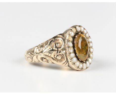 A Victorian gold, foil backed citrine and half-pearl oval cluster ring, the foil backed citrine mounted within a surround of 