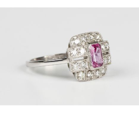 A platinum, pink sapphire and diamond cluster ring in an Art Deco inspired design, collet set with the cut cornered rectangul