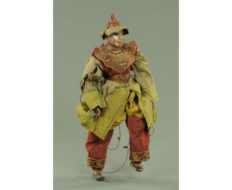 An Eastern carved and painted wood puppet of a man, early to mid 20th century, dressed in traditional dress, 48 cm high.