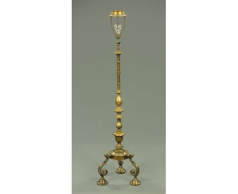 A brass lamp standard, raised on Portuguese style scroll legs.