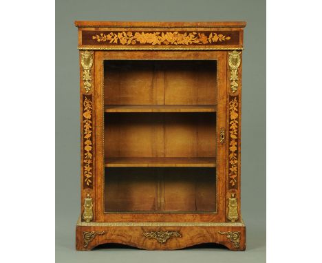 A Victorian walnut foliate marquetry pier cabinet, with single glazed door flanked by flat pilasters, with metal mounts and r