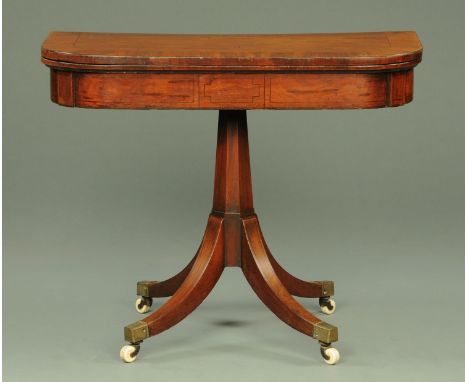 A Regency mahogany turn over top card table, with crossbanded edge and recessed geometric strung frieze, with faceted column 