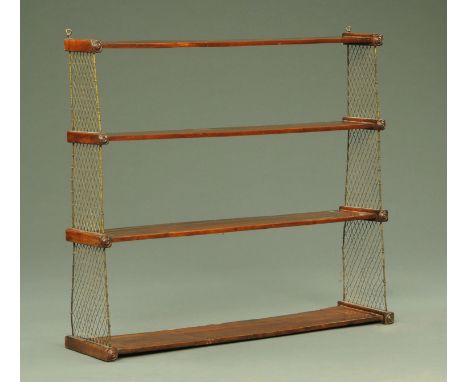 A Regency mahogany four tier graduated hanging shelf unit, with wired sides.  Width 95 cm.  CONDITION REPORT: The shelves are