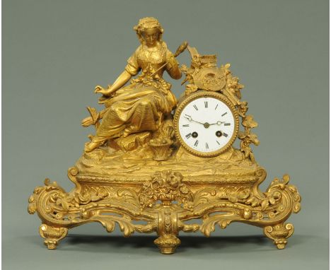 A 19th century French spelter figural mantle clock, gilt, with two-train movement and striking on a bell.  Width 43 cm. 