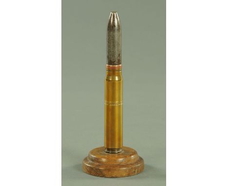 A Great War Trench Art table lighter, constructed from a 20 mm cannon cartridge, on a turned wood base, overall height 21 cm.