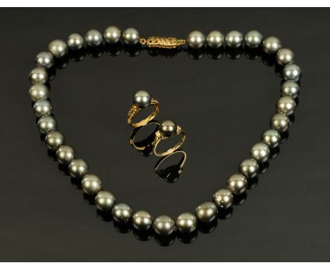 Two 18 ct yellow gold pearl and diamond set rings, and a matching pearl necklace with 18 ct gold clasp.  Ring size O.  The pe