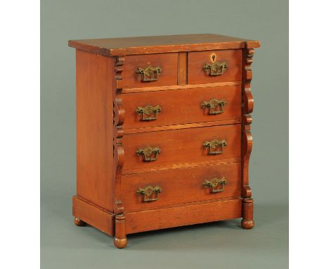 A Victorian mahogany miniature Scotch chest of drawers, with inverted breakfront, two short and three long drawers with brass