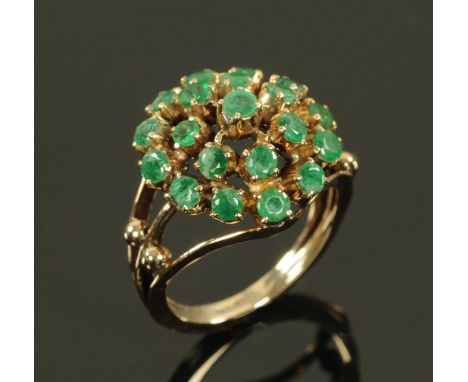 An Emerald set cluster ring, on rose gold coloured metal shank, unmarked but believed to be 18 ct, size N, gross weight 5.75 