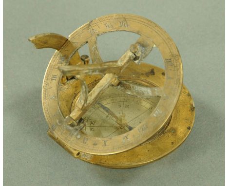 A lacquered brass pocket sundial compass, 18th century, the compass with silvered dial, with folding gnomon and graduated qua