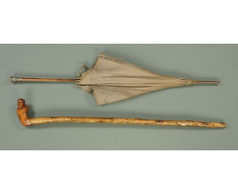 A silver mounted parasol, and a walking stick with figural handle.