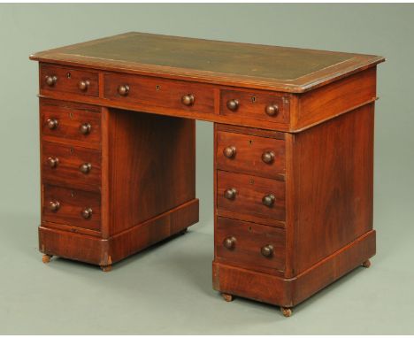 A Victorian mahogany kneehole desk, with leatherette writing surface above a series of drawers with turned knob handles, on p