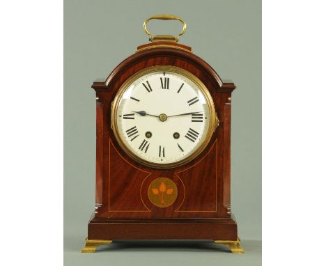 An Edwardian inlaid mahogany bracket clock, in the Georgian style, with an arched top with round enamel dial and two-train mo