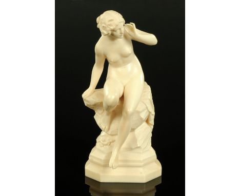 Johann Balthasar Trumpfheller, carved ivory figure of "Echo", circa 1930, carved seated upon a draped boulder with a lizard a