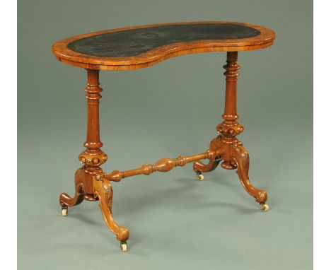 A Victorian walnut kidney shaped stretcher table, with tooled leather surface, turned supports and downswept legs terminating