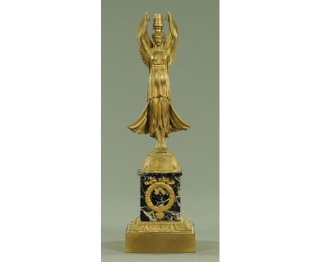 A brass table lamp, in the form of an angel holding a loft a light fitting and raised on a marble and brass base.  Height 47 