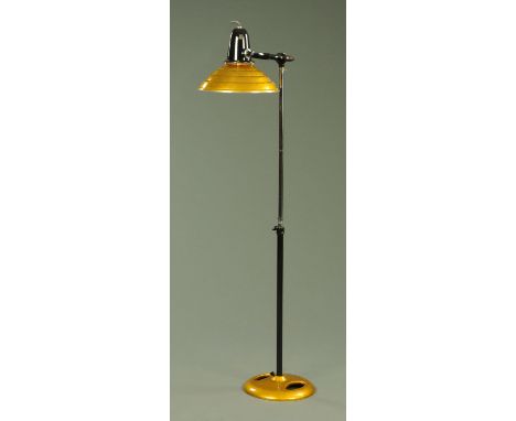 A steam punk inspired standard lamp, manufactured from parts of a mid 20th century heat lamp, with adjustable shade, all upon
