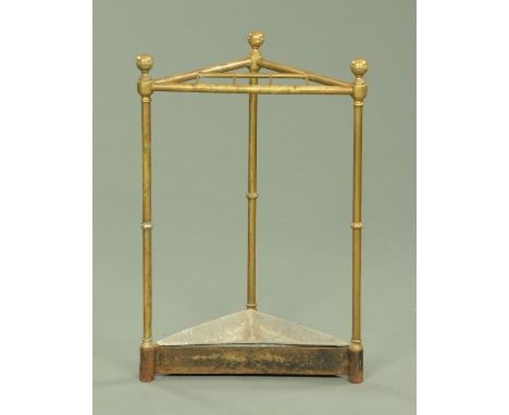 A Victorian brass corner stick stand, with knop terminals, the cast base with zinc liner, 62.5 cm high, 41.5 cm wide.