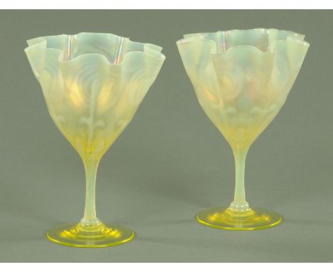 A pair of James Powell attributed Art Nouveau Vaseline glass vases, late 19th century, each with frilled edge and stylised fl