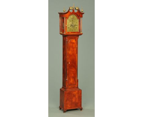 An Edwardian mahogany longcase clock, with swans neck pediment and arched glazed door enclosing the brass dial and two-train 