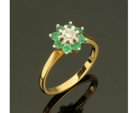 An 18 ct gold diamond and emerald cluster ring, size N. CONDITION REPORT: Weight 2.4 grams.