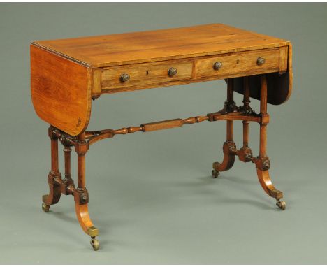 A late George III rosewood sofa table, with two D shaped flaps and boxwood borders to the rectangular top above a pair of cro