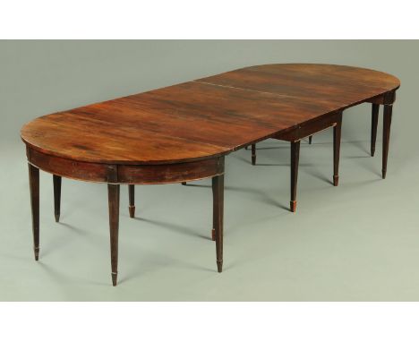 A George III mahogany dining table, with centre drop leaf section and two D ends all raised on tapered legs of square section