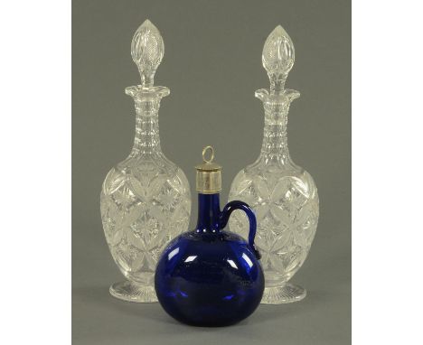 A good pair of cut glass decanters with stoppers, early 20th century, with a ribbed neck and faceted shoulder above a star an