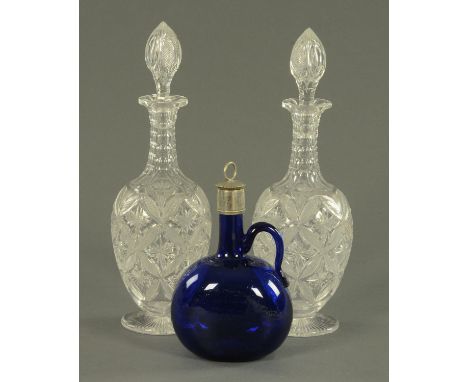 A good pair of cut glass decanters with stoppers, early 20th century, with a ribbed neck and faceted shoulder above a star an