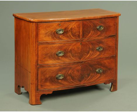 A Victorian mahogany bowfronted chest of drawers, with two short and two long graduated drawers with brass drop handles with 