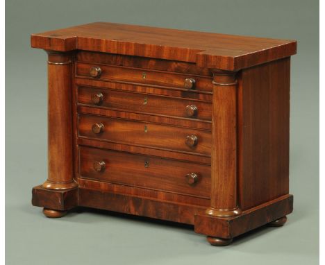 A Victorian mahogany miniature Scotch chest of drawers, with inverted breakfront, four drawers and turned columns all raised 
