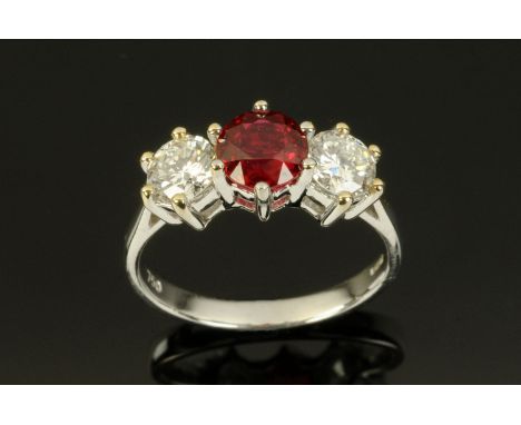 An 18 ct white gold ruby and round brilliant cut diamond three stone ring, ruby weight +/- 1.18 carats, size M (see illustrat