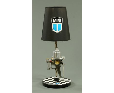 A Steam Punk inspired table lamp, manufactured from a Mini carburettor, with Mini branded shade and base, height 70 cm.