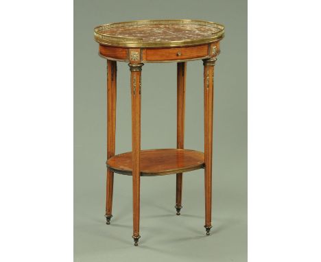 A Continental style occasional table, oval, with marble top and brass gallery, single drawer and raised on turned and fluted 