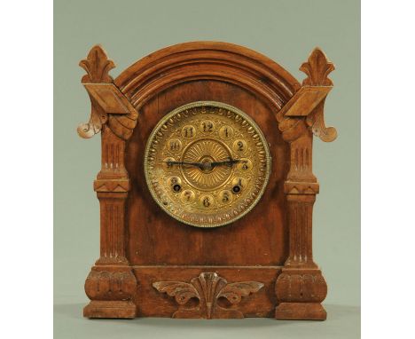 An Edwardian carved walnut cased mantle clock, two-train striking on a gong and with American Ansonia movement.  Height 31 cm