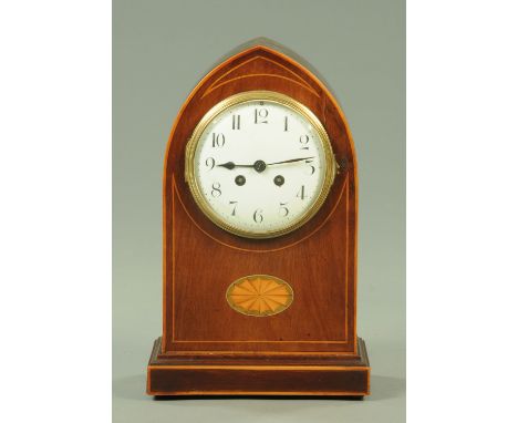 An Edwardian mahogany mantle clock, with arched boxwood strung case and with fan medallion, two-train movement, Arabic numera